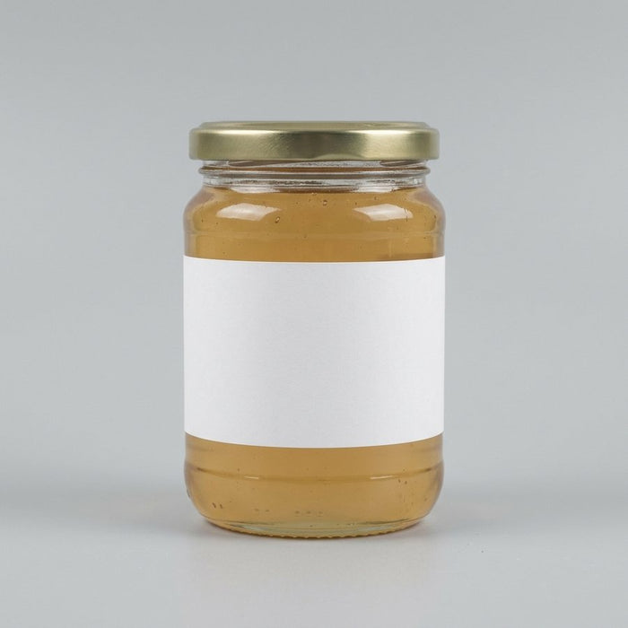 A plain unbranded honey jar with a blank label